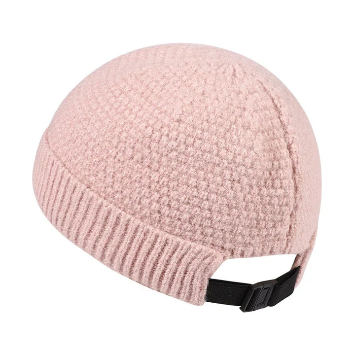 Pink textured knit beanie hat with adjustable black strap at back
