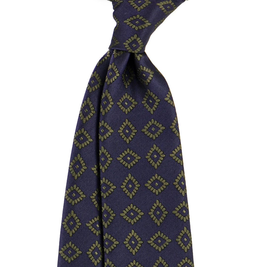 Navy blue silk tie with gold geometric diamond pattern in classic knot
