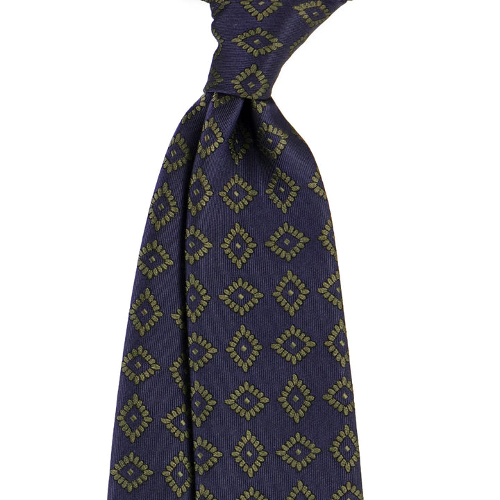 Navy blue silk tie with gold geometric diamond pattern in classic knot