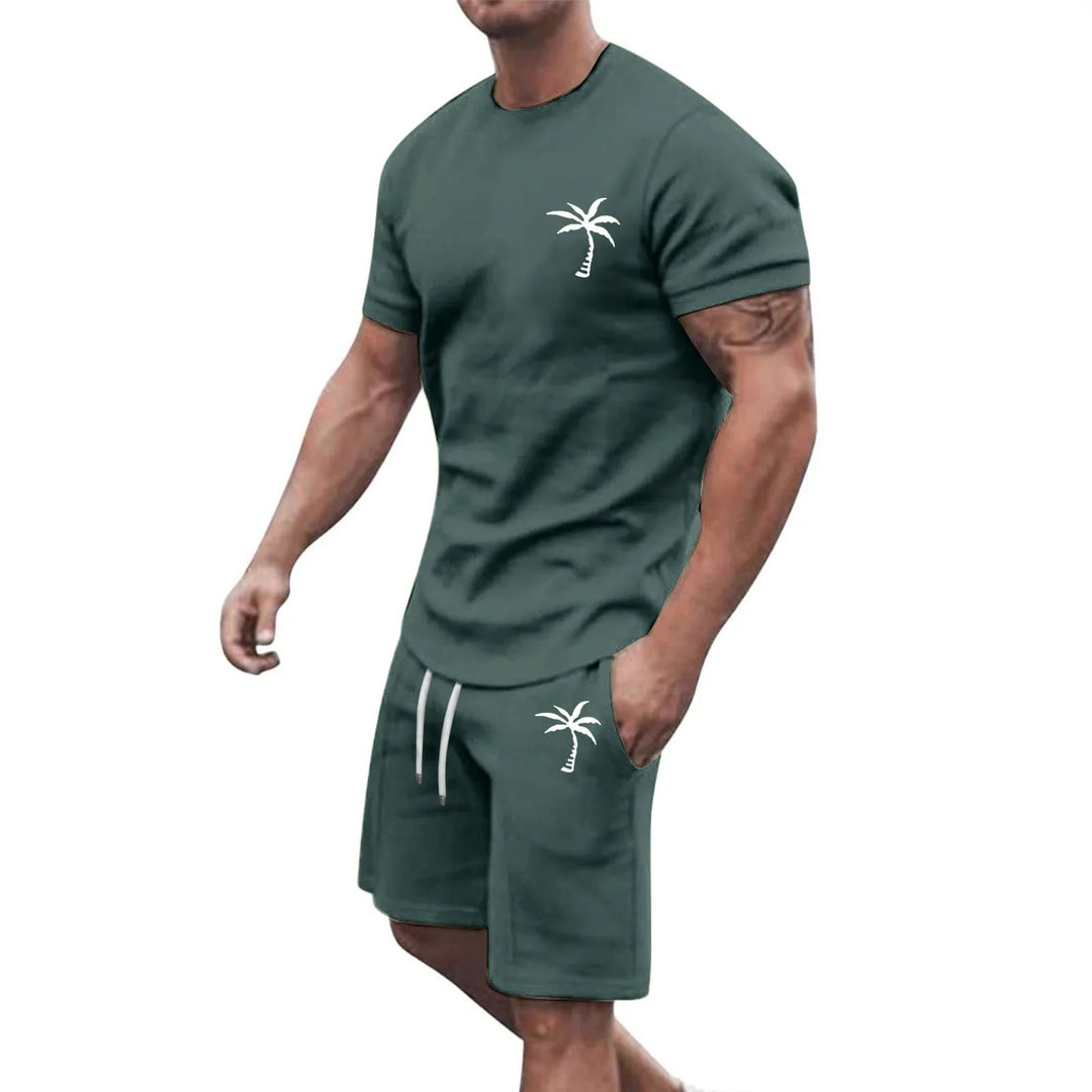 Muscular man wearing dark green casual t-shirt and shorts set with white palm tree logo
