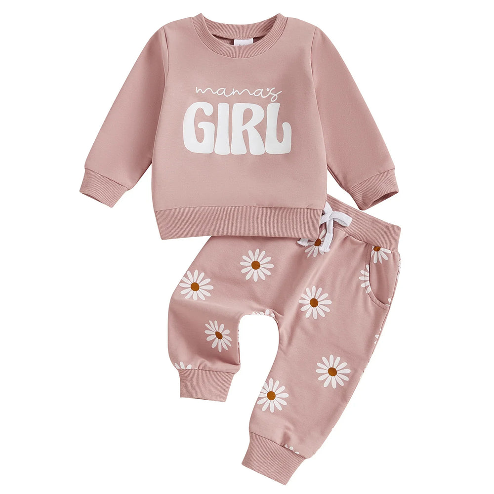 Pink toddler girl outfit with long sleeve top reading 'mama's girl' and daisy print pants