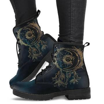 Blue leather lace-up boots with dreamcatcher design worn with black pants