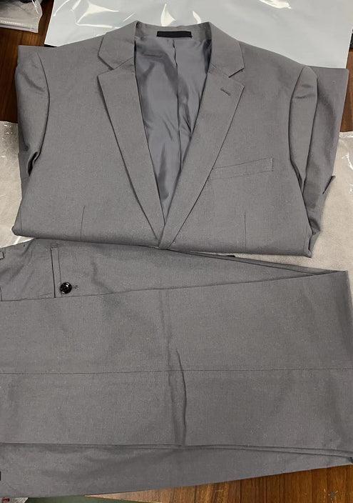 Gray men's two-piece suit with blazer and trousers laid flat on a wooden surface