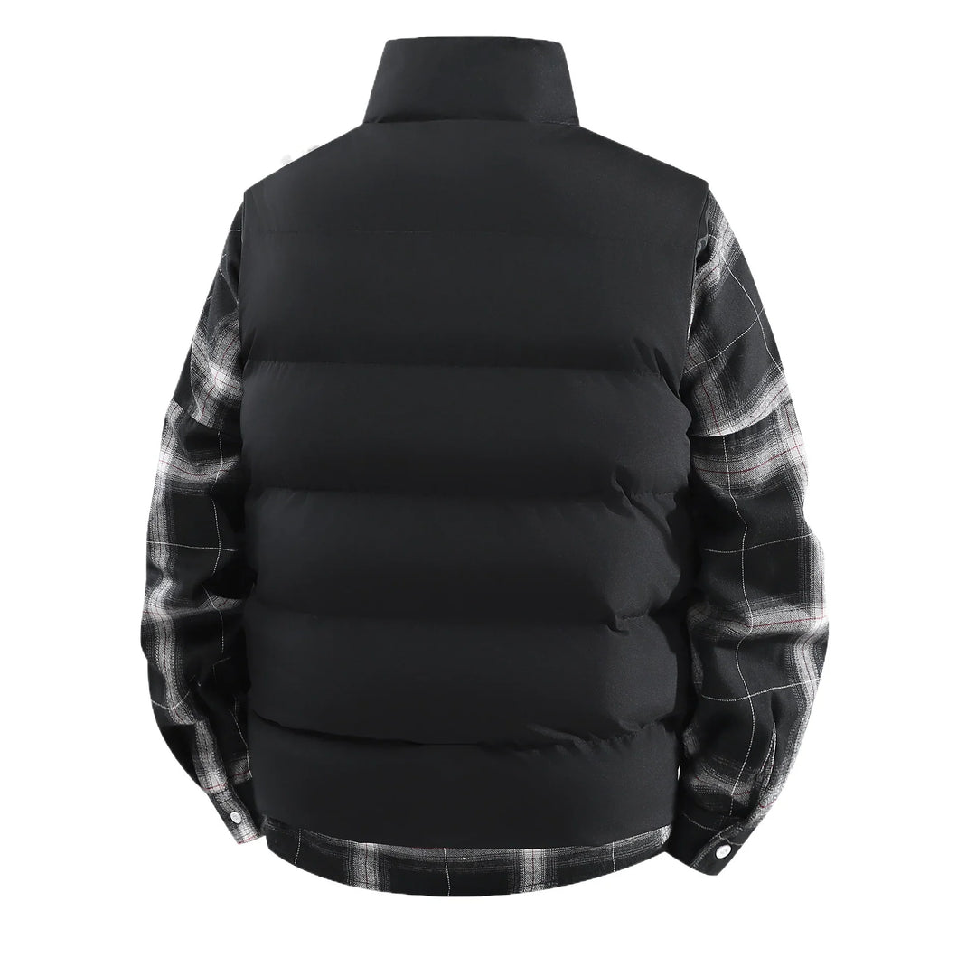 Back view of black puffer vest layered over black and white plaid shirt with buttoned cuffs