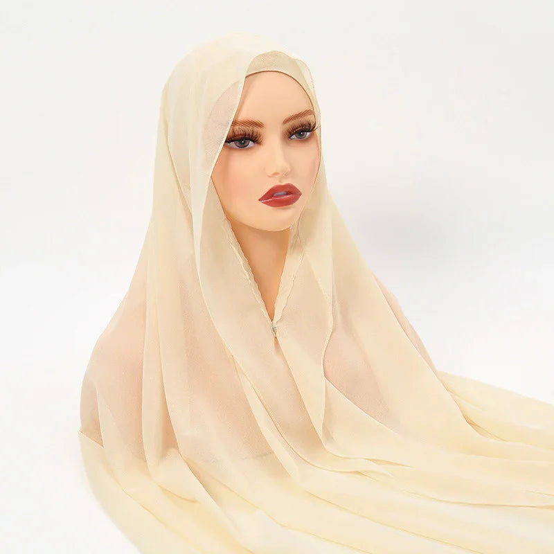 Beige chiffon hijab on mannequin with natural makeup, long lashes, and red lipstick