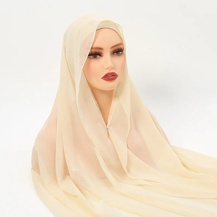 Beige chiffon hijab on mannequin with natural makeup, long lashes, and red lipstick