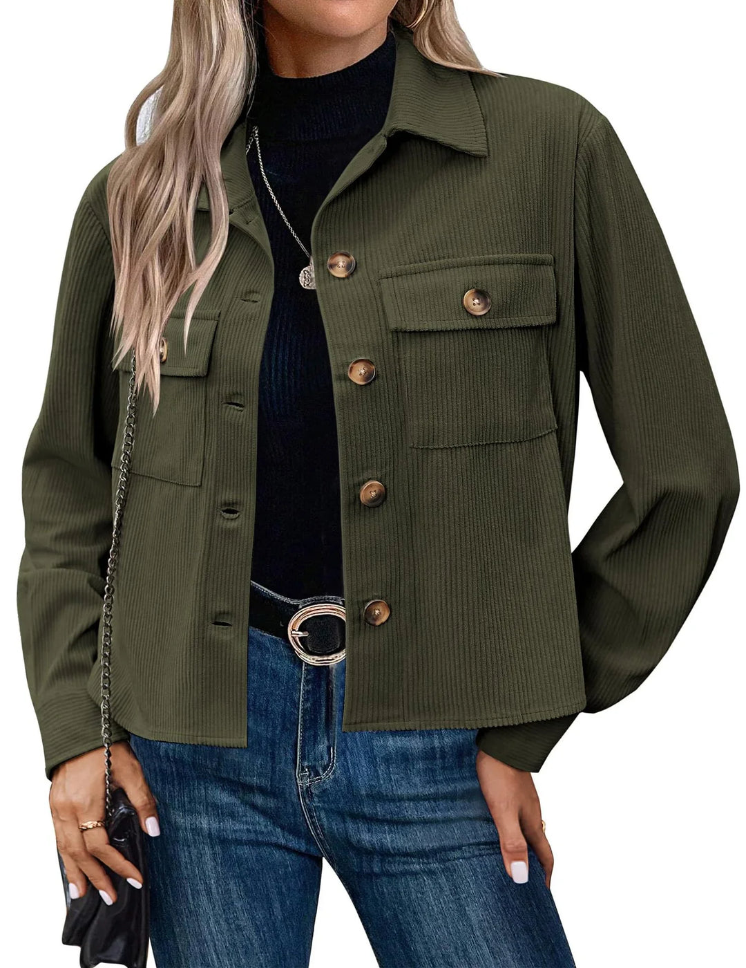 Woman wearing olive green ribbed button-up jacket with chest pockets over black top and blue jeans