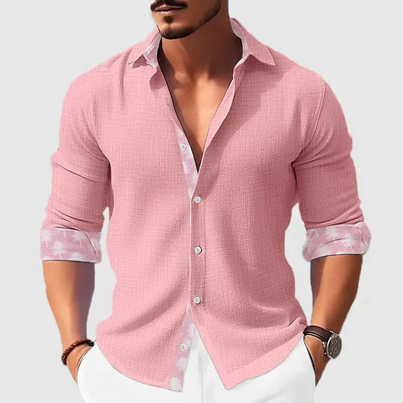 man wearing casual pink textured long-sleeve shirt with rolled cuffs and white pants