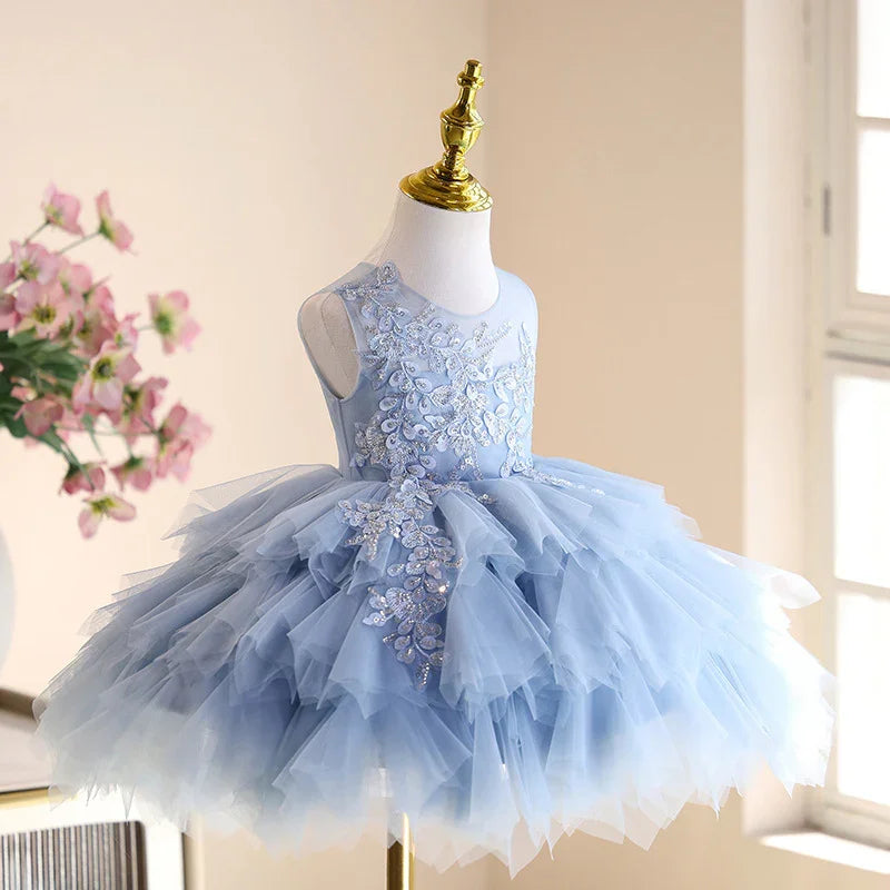Elegant light blue sleeveless baby girl dress with floral embroidery and layered tulle skirt on mannequin