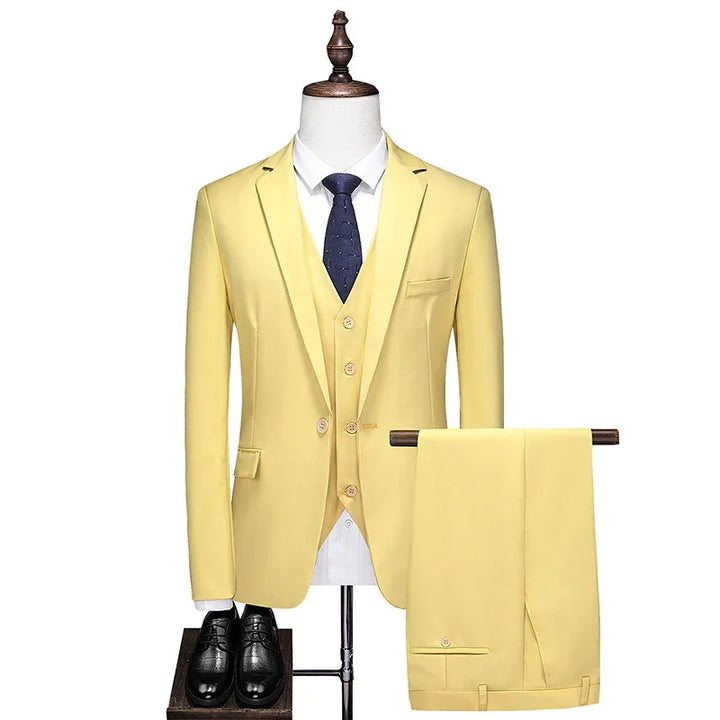 Yellow three-piece men's suit with blazer, vest, and trousers, paired with white shirt, navy tie, and black shoes