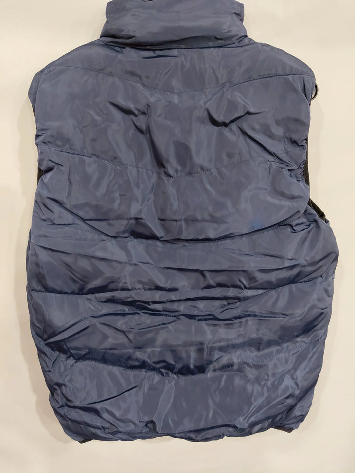 back view of navy blue padded sleeveless winter vest with quilted stitching