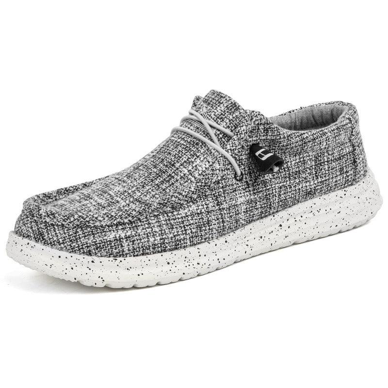 Gray textured casual slip-on shoe with speckled white sole and elastic laces