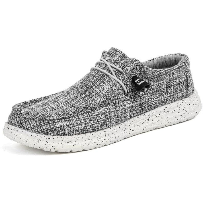 Gray textured casual slip-on shoe with speckled white sole and elastic laces