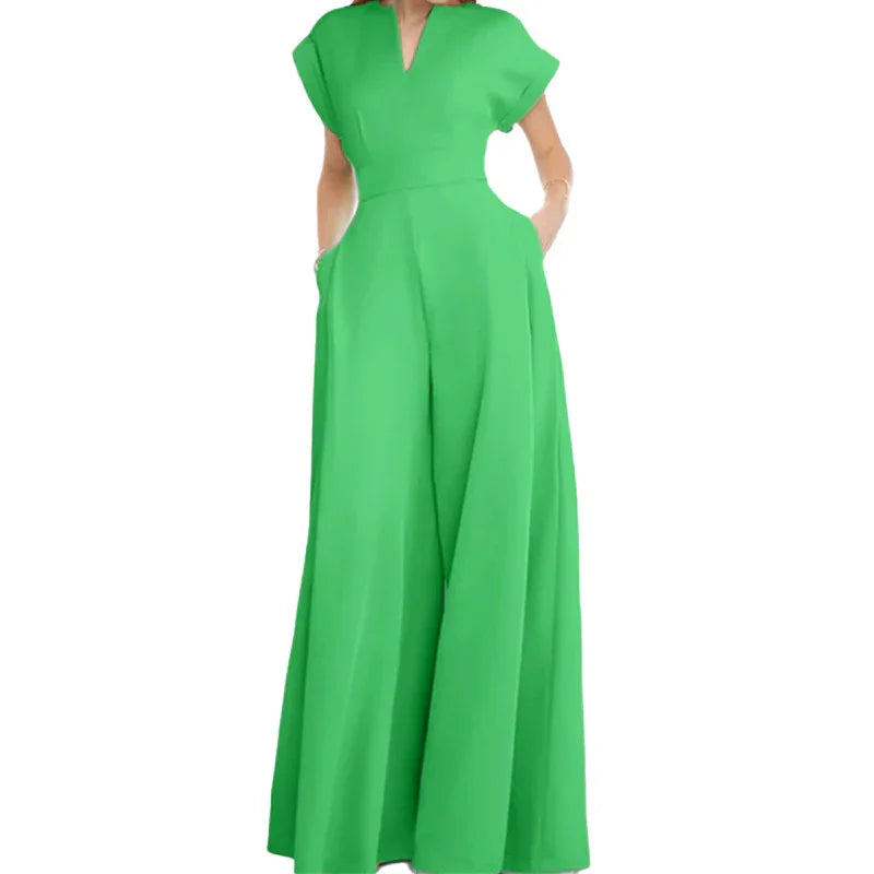 Woman wearing a vibrant green wide-leg jumpsuit with short sleeves and V-neck