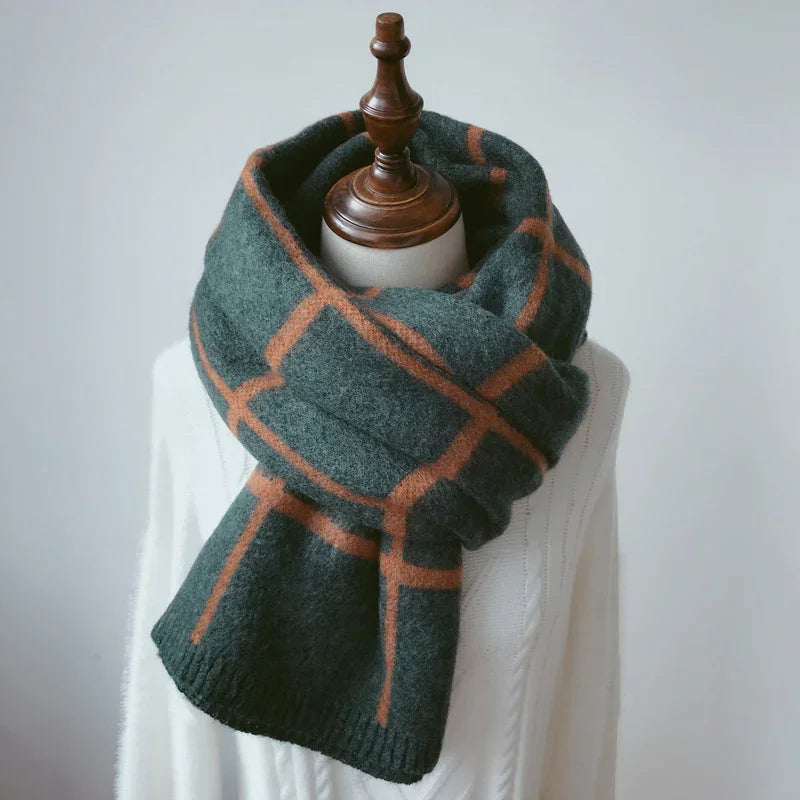 Dark green and brown checkered wool scarf on mannequin dressed in white knit sweater