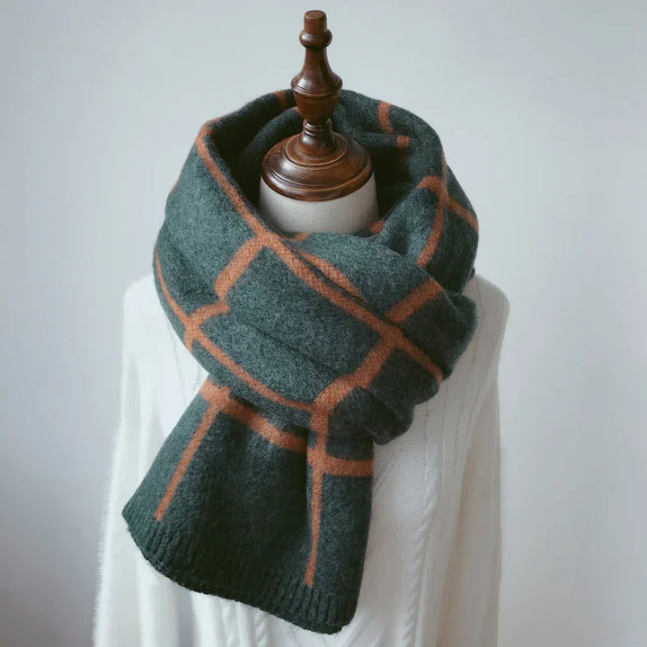 Dark green and brown checkered wool scarf on mannequin dressed in white knit sweater