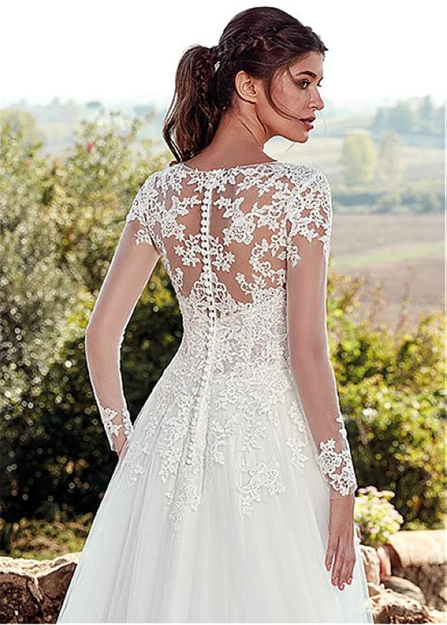 Bride wearing white lace long sleeve wedding dress with floral embroidery and buttoned back outdoors