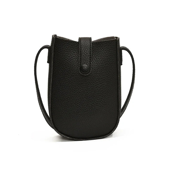 Black textured leather crossbody bag with snap closure and slim shoulder strap