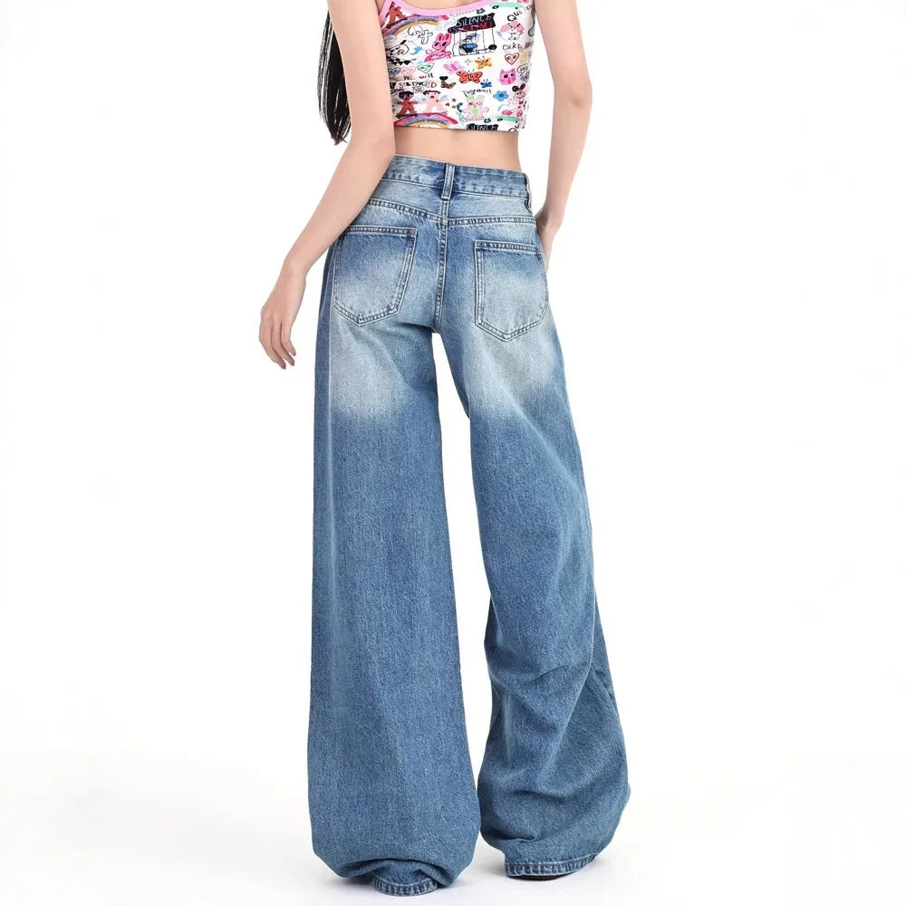 Back view of woman wearing wide leg blue denim jeans with faded wash details