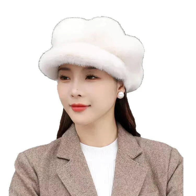 Woman wearing a white fluffy winter hat, pearl earrings, and a brown herringbone blazer