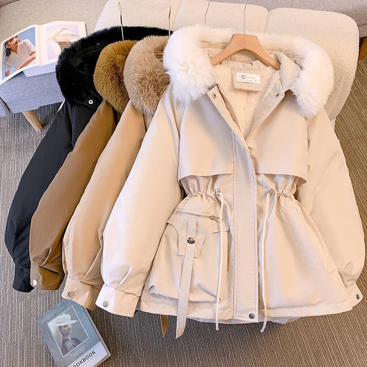 Four winter jackets in black, brown, beige, and cream with fur-trimmed hoods hanging on a chair
