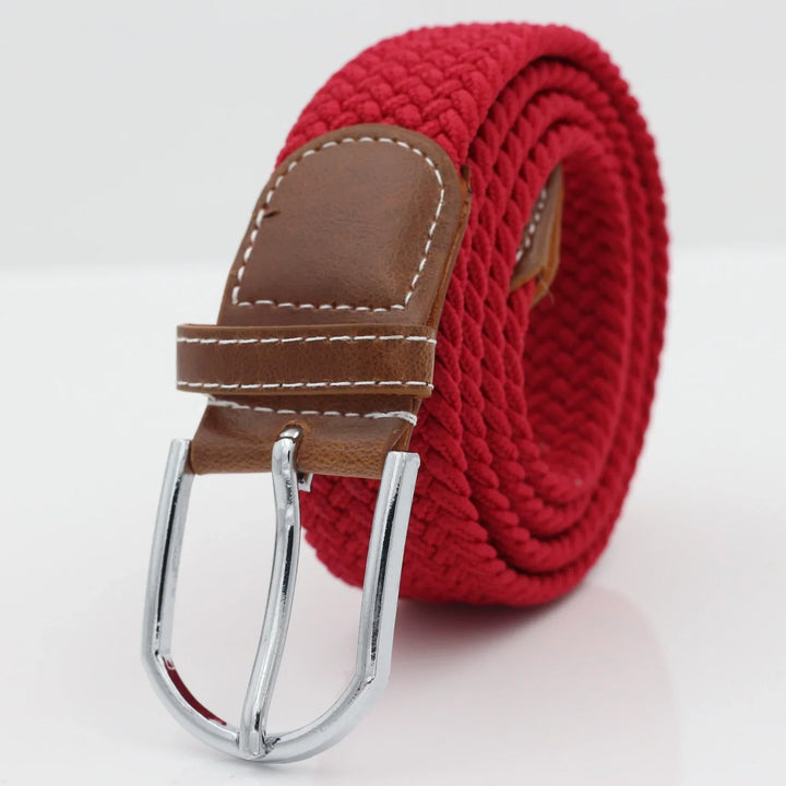 Red woven fabric belt with brown leather detailing and silver metal buckle on white background