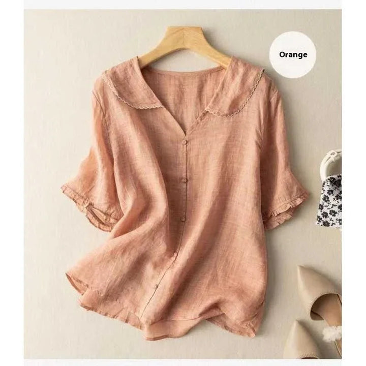 Orange lightweight linen blouse with scalloped collar and buttons, displayed on wooden hanger