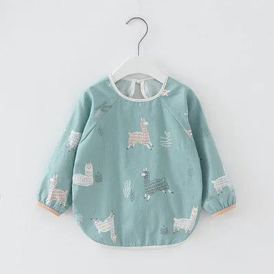 Light blue toddler long-sleeve shirt with llama and plant prints on white hanger