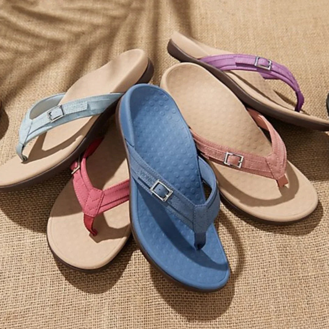 Comfortable women's thong sandals in blue, pink, and purple with cushioned beige soles on woven fabric