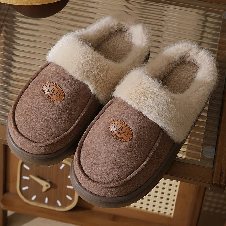 Brown cozy slippers with fluffy beige fur lining on a wooden table near a vintage clock