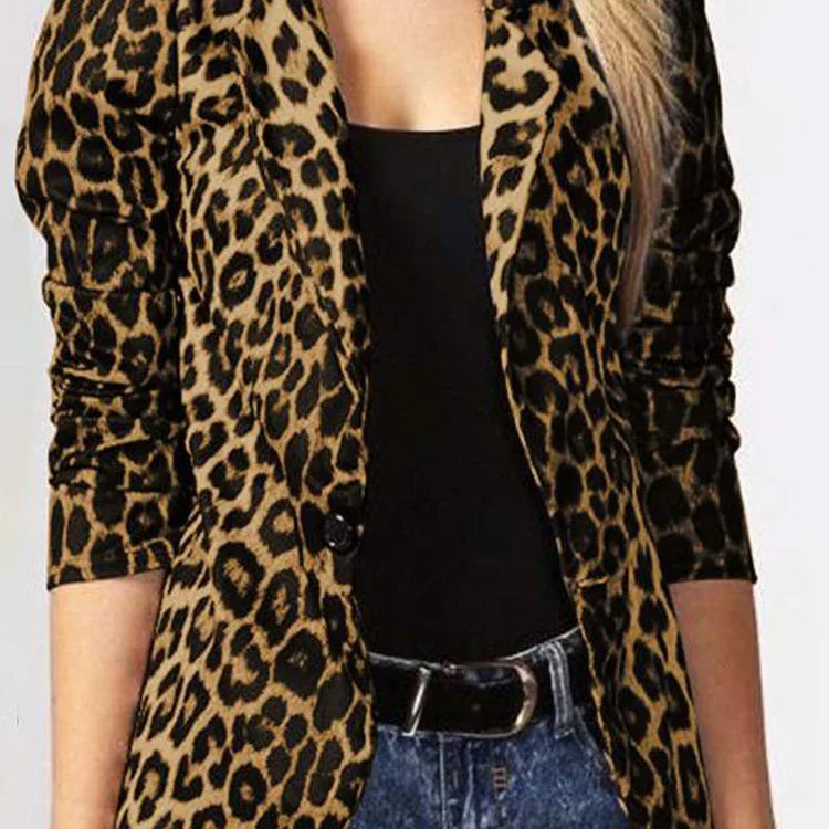 Woman wearing a leopard print blazer over black top with blue jeans and black belt