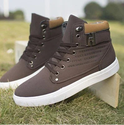 Brown high-top canvas sneakers with white soles and lace-up front on grass outdoors