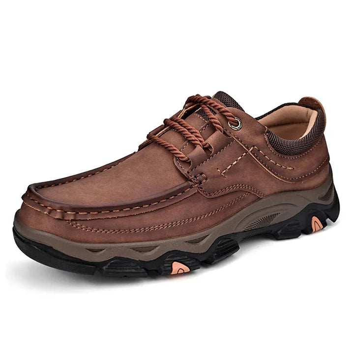 Brown leather hiking shoe with rugged black sole and rope-style laces on white background
