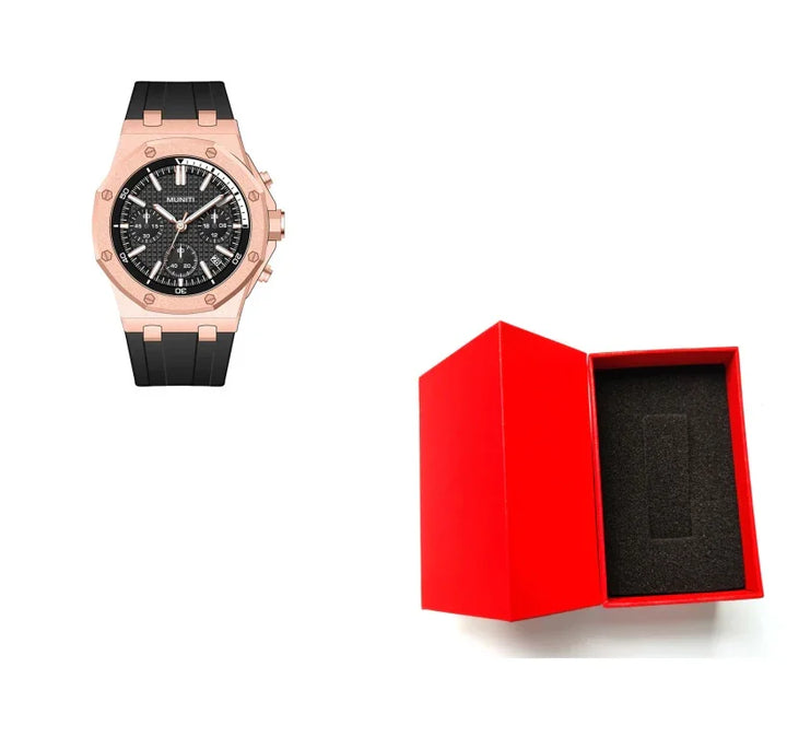 Rose gold wristwatch with black dial and strap next to open red watch box with foam insert