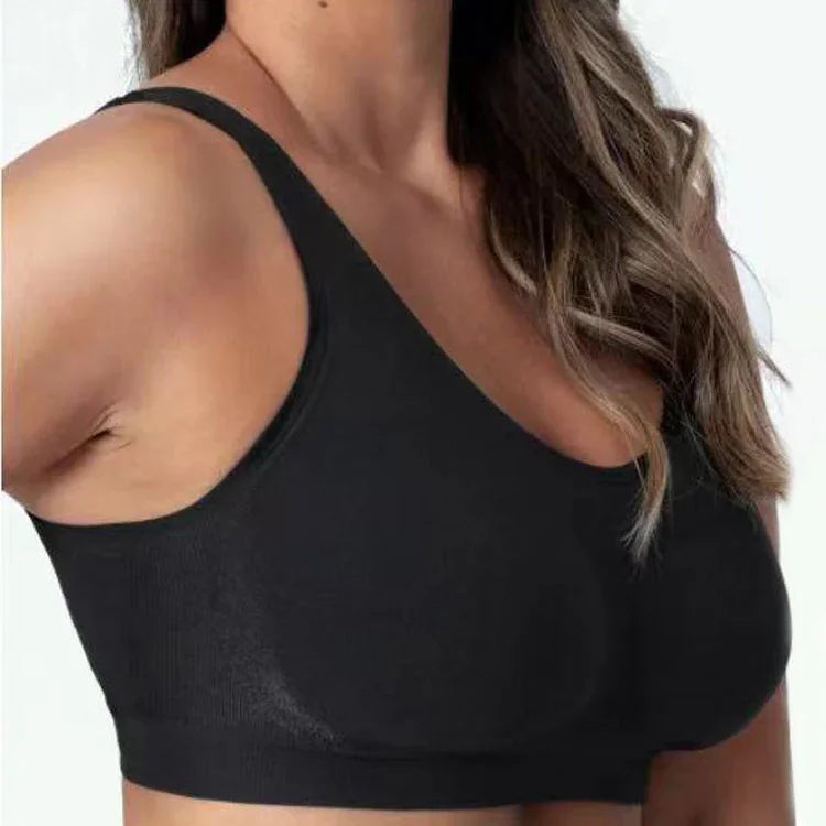 Close-up of a woman wearing a black seamless sports bra with thin straps and wavy hair