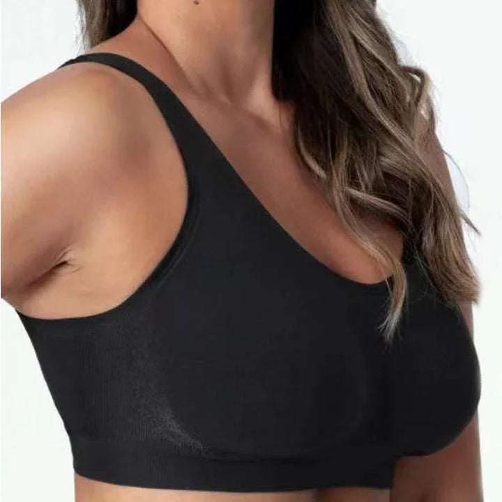 Close-up of a woman wearing a black seamless sports bra with thin straps and wavy hair