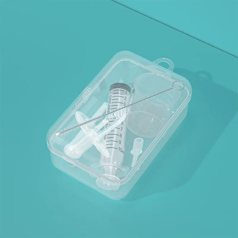clear plastic kit with syringe, small brush, measuring cup, and a white nozzle on turquoise background