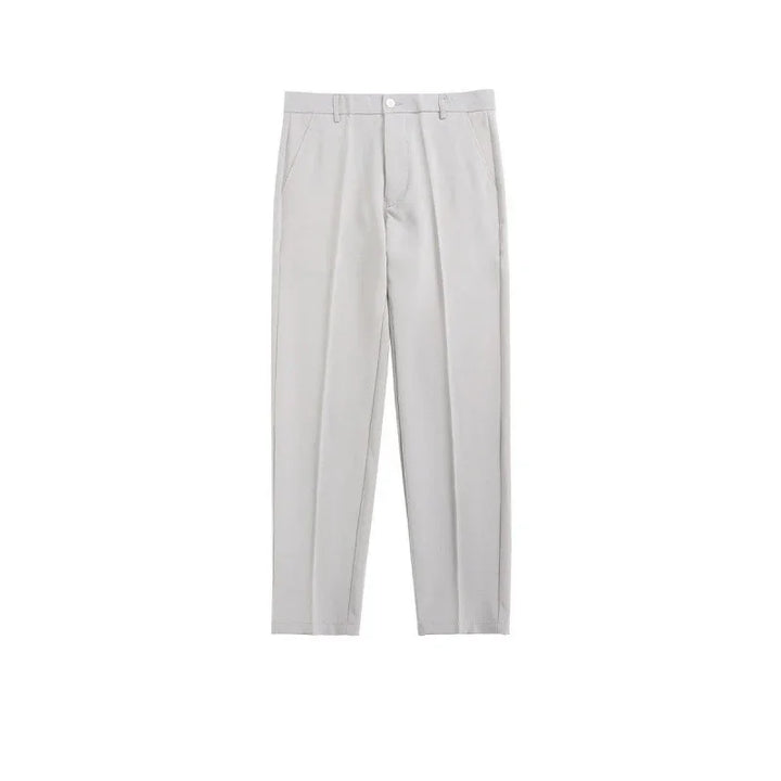 Light gray formal trousers with pleats and side pockets on white background
