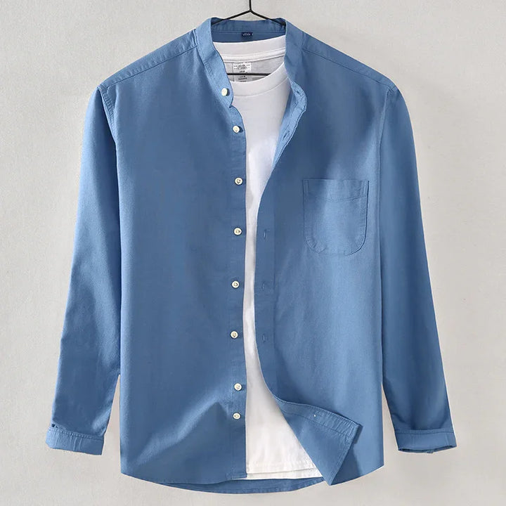 Men's casual blue cotton shirt with mandarin collar over white t-shirt on hanger