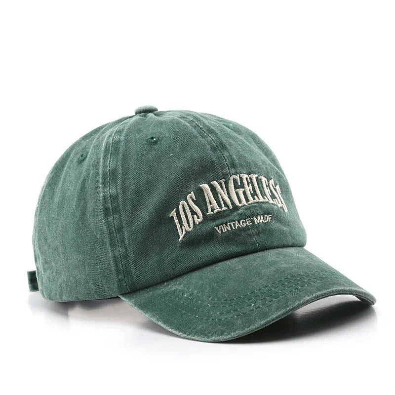 Green vintage-style baseball cap with embroidered text 'LOS ANGELES VINTAGE MADE' on front