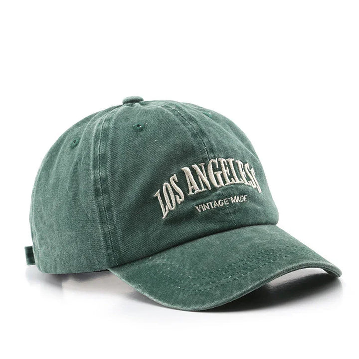 Green vintage-style baseball cap with embroidered text 'LOS ANGELES VINTAGE MADE' on front
