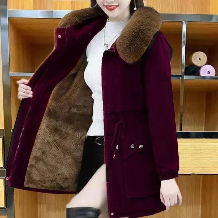 woman wearing stylish dark purple winter coat with faux fur collar and warm brown lining