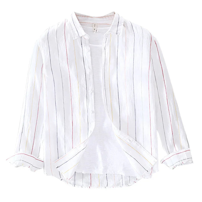 White button-up shirt with multicolor vertical stripes and rolled sleeves over white tee