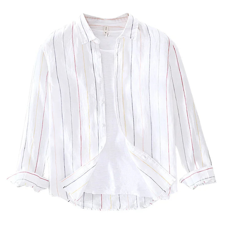 White button-up shirt with multicolor vertical stripes and rolled sleeves over white tee