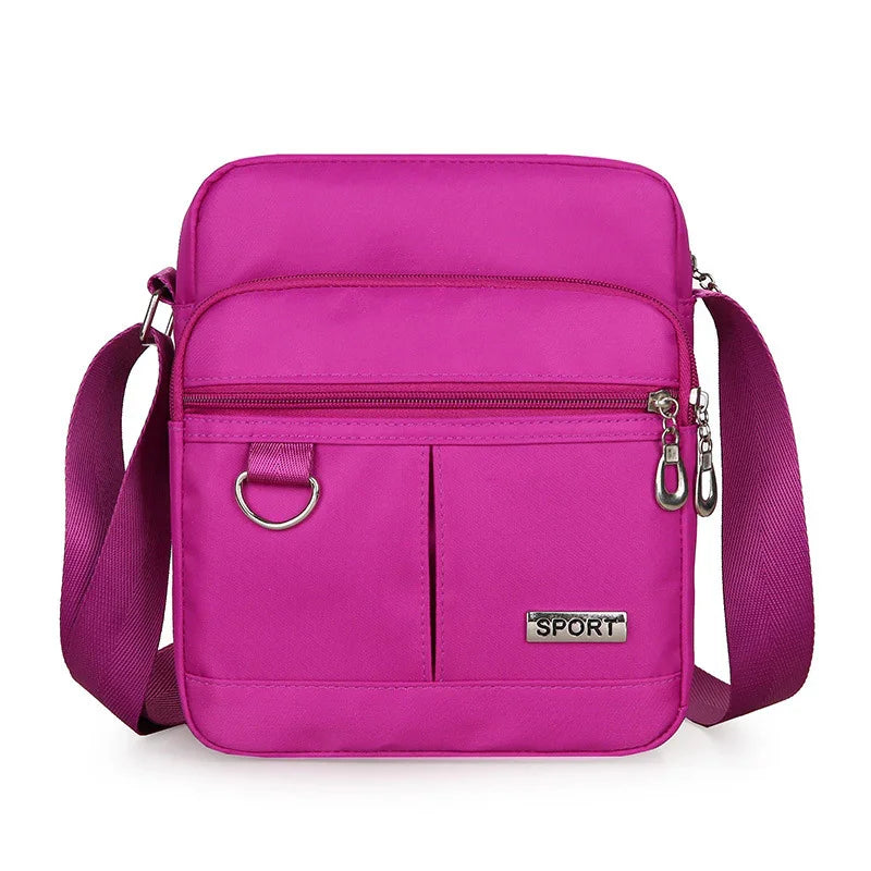 Compact bright pink sport shoulder bag with adjustable strap and multiple zippered pockets
