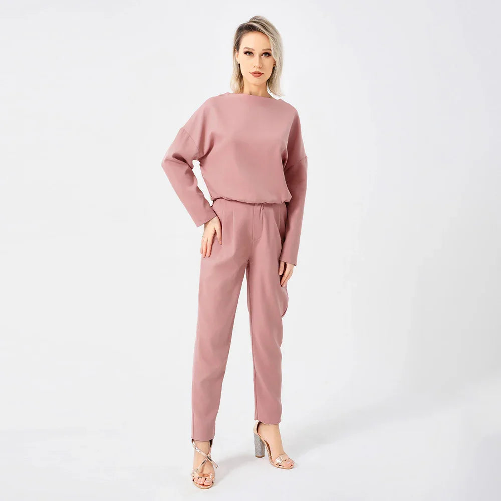 Woman modeling mauve long-sleeve top and matching pants with silver high heel sandals