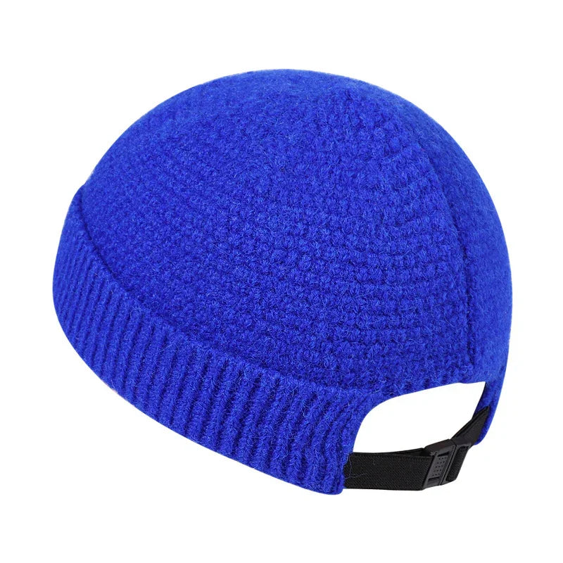 Blue knitted winter beanie hat with adjustable black strap on white background