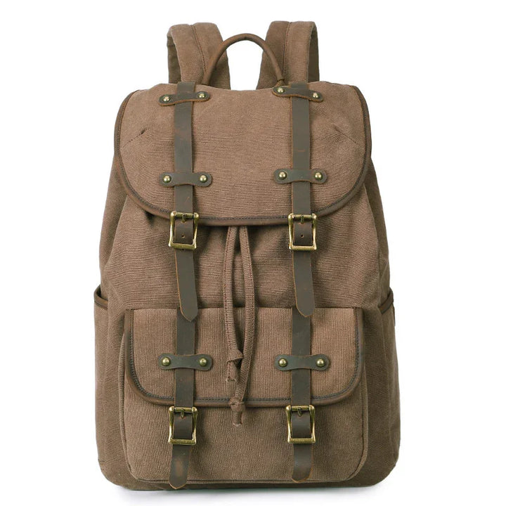 Brown canvas backpack with front buckled straps and flap closure, designed for outdoor and daily use