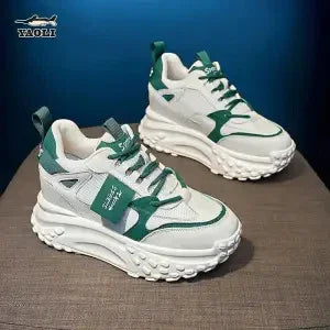 White and green Waoli branded chunky sneakers with textured soles on a dark surface