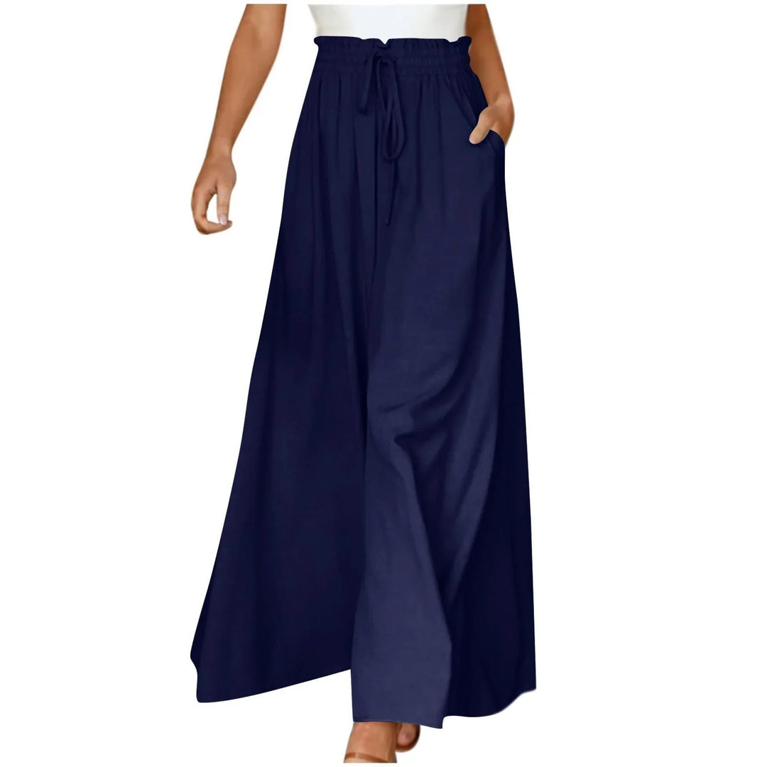 Woman wearing navy blue wide leg palazzo pants with drawstring waist and pockets